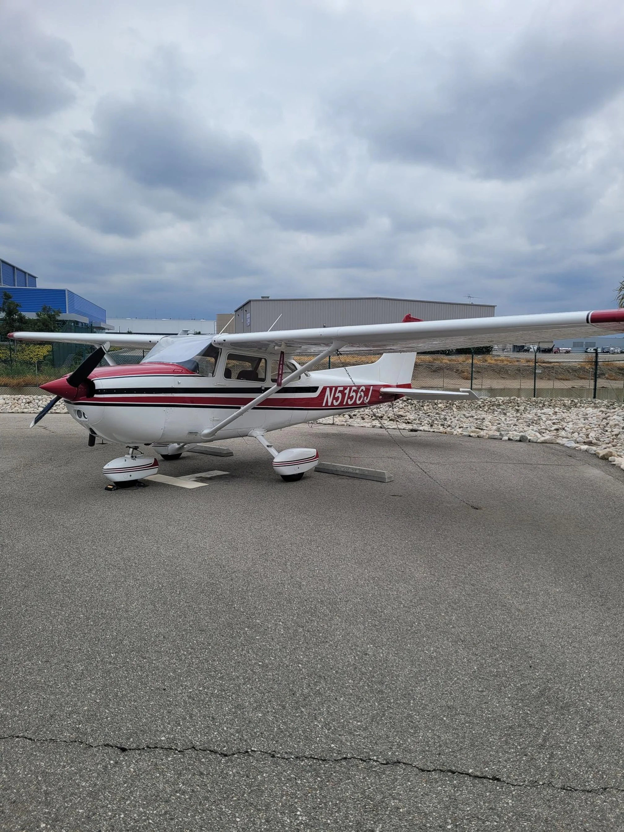 Cessna 172N training airplane parked outside a hangar