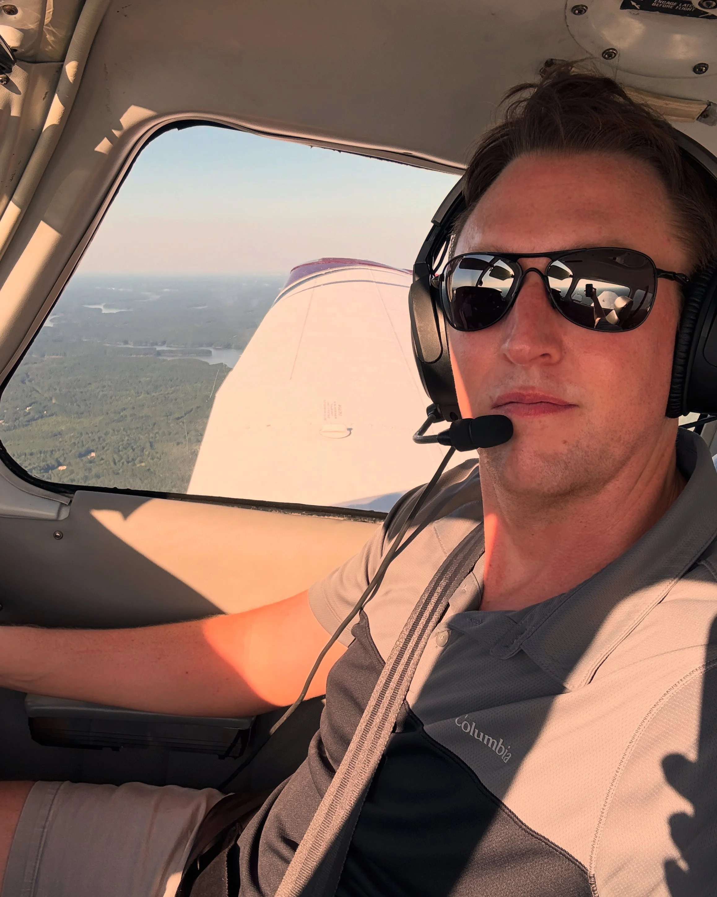 Robbie flying from the left seat with a headset on